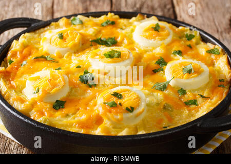 Anglesey Eggs  baked with boiled mashed potatoes, leek cheese sauce close-up on the table. horizontal Stock Photo