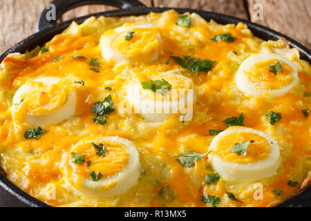 English cuisine Anglesey Eggs: mashed potatoes casserole with leek, cheese and eggs in a saucepan. horizontal Stock Photo