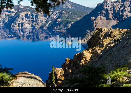 Phantom ship feature in Crater Lake national park, with beautiful reflection on the deep blue water Stock Photo