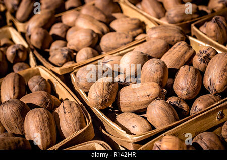 In-shell pecans are sold in baskets at Market in the Park in Cathedral Square, Nov. 3, 2018, in Mobile, Alabama. Stock Photo