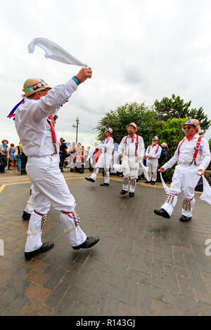 Broadstairs Folk Week festival. Traditional English Folk dancers, the Hartley Morris side, dancing outdoors on the seafront promenade. Stock Photo