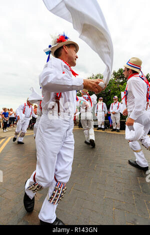 Broadstairs Folk Week festival. Traditional English Folk dancers, the Hartley Morris side, dancing outdoors on the seafront promenade. Stock Photo