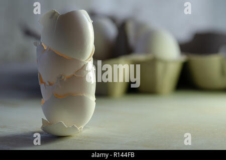 Close up of broken egg shells on wooden background,blurred background. Stock Photo
