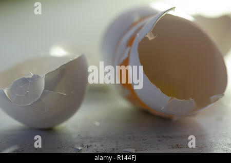 Close up of broken egg shells on wooden background,blurred background. Stock Photo