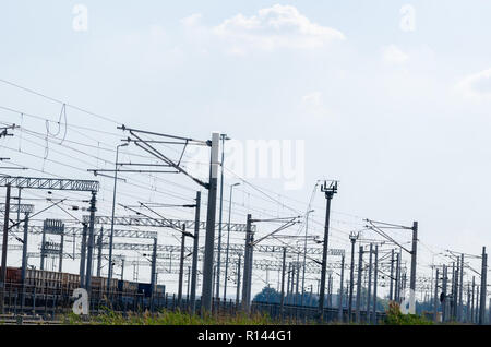 Tram wires (overhead lines, railroad trolley line)and masts  on the sky background. Stock Photo
