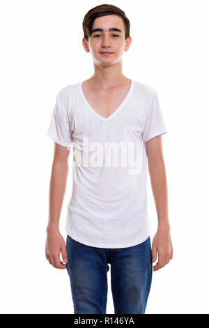 Studio shot of young handsome Persian teenage boy standing Stock Photo