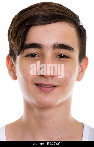 Face of young happy Persian teenage boy smiling Stock Photo