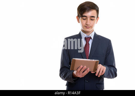 Studio shot of young handsome Persian teenage businessman using  Stock Photo