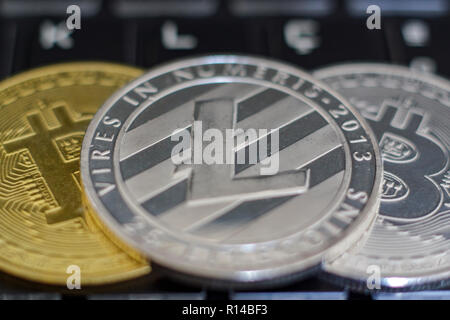 Cryptocurrency coins on computer keyboard Stock Photo