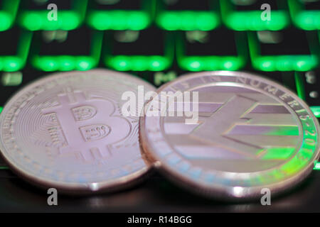 Cryptocurrency coins on illuminated computer keyboard Stock Photo
