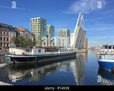 The draw bridge is raised for a barge as it cruises thru the waterway in Antwerp Belgium. Stock Photo