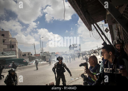 Israeli Border Police seen harassing several journalist during the protest. As the US government moves the embassy to Jerusalem, thousands of Palestinians protest in Gaza and the West Bank the same day that marks the 70th anniversary of the Nakba. In Gaza, Israeli troops shot to death more than 58 people and injured 2,000 on that day. At Qalandiya military checkpoint hundreds marched and threw stones at Israeli soldiers, who responded with firing live bullets, rubber bullet and also tear gas. Stock Photo