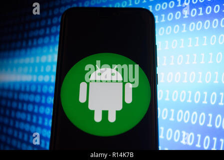 Android logo is seen on an Android mobile device. Stock Photo