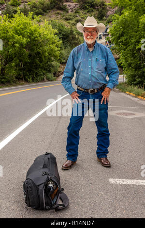 July 20, 2018, OURAY COLORADO, USA - Cowboy hitch hikes along route 550 outside of Ouray, Colorado Stock Photo