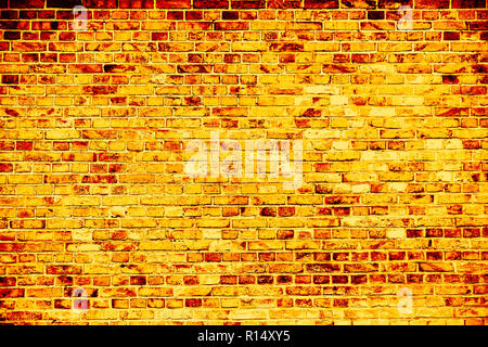 Simple grungy yellow gold brick wall as seamless pattern texture background. Stock Photo