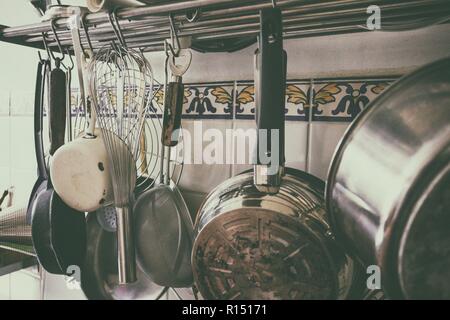 vintage processing - kitchen utensils hanging in the kitchen Stock Photo