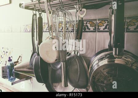 vintage processing - kitchen utensils hanging in the kitchen Stock Photo
