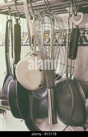 vintage processing - kitchen utensils hanging in the kitchen Stock Photo