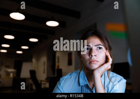 Photo of concentrated young woman graphic designer using pc computer working at night in office. Stock Photo