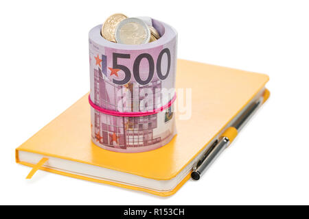 euro money bundle tied with a rubber band on a yellow notepad with pen, isolated on white background Stock Photo