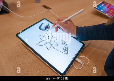 graphic designer girl drawing sketch on digital tablet screen with stylus pencil Stock Photo