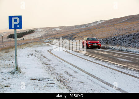 A car driving through fresh snow in Assynt, Scotland, UK. Stock Photo