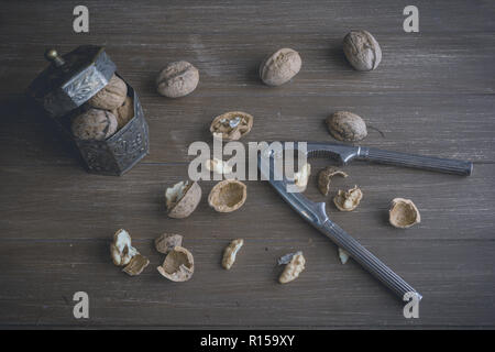 Walnuts lying on a brown tray with a nutcracker Stock Photo