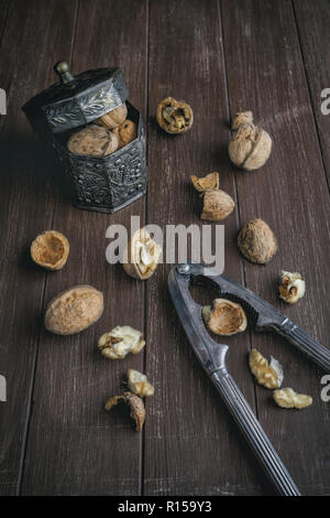 Walnuts lying on a brown tray with a nutcracker Stock Photo