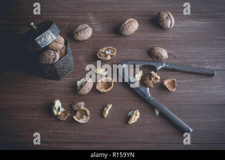Walnuts lying on a brown tray with a nutcracker Stock Photo