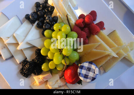 Different tasty snacks and cheese for wine on luxury banquet table plate Stock Photo