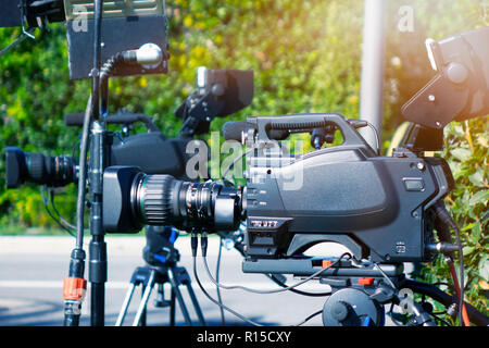 Video clip. Video camera in the rays of light. TV camera A television. Live broadcast. Record video. Stock Photo