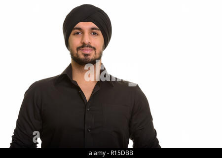 Portrait of young handsome Indian Sikh man Stock Photo
