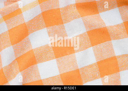 orange and white checkered creased  kitchen towel background texture Stock Photo
