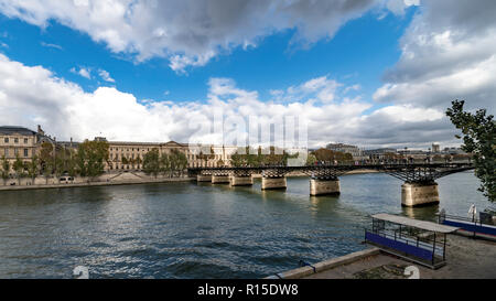 The pedestrian 'Pont des arts' bridge leads to the Louvre palace where lovers around the world used to celebrate their love hooking a lock on it and t Stock Photo