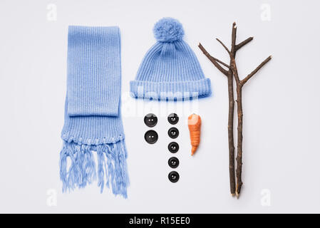 How to make a snowman. Hat, scarf, carrot, buttons and tree branches - set for winter fun Stock Photo