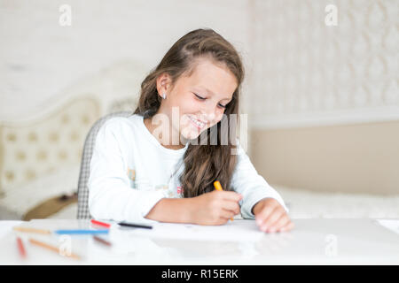 dreamy kid girl drawing with color pencils Stock Photo