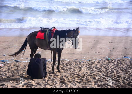 Landscap of unidentified horse owner waiting for tourists at Hawks Bay, Karachi, Pakistan. Stock Photo