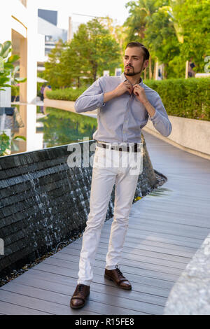 Portrait of young bearded fashionable man outdoors Stock Photo