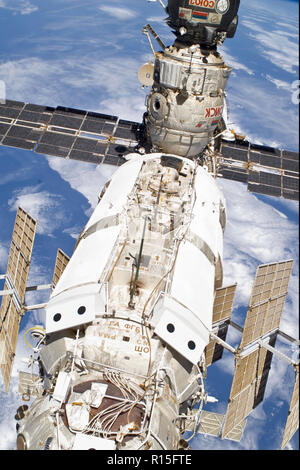 The main portion of the International Space Station first module, the Zarya cargo module with the solar arrays and the Poisk Mini-Research Module-2 that hosts the docked Soyuz TMA-18 crew craft May 17, 2010 in Earth Orbit. Stock Photo