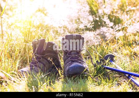 travel. the tourist goes on a hike through the mountains - a boots and Trekking poles Stock Photo