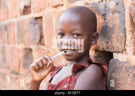 Cheerful 11 year old girl wearing pink t-shirt and black pants with waving  long blond hair dancing. isolated on grey background Stock Photo - Alamy