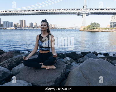 Young athletic woman doing yoga in New York City Stock Photo