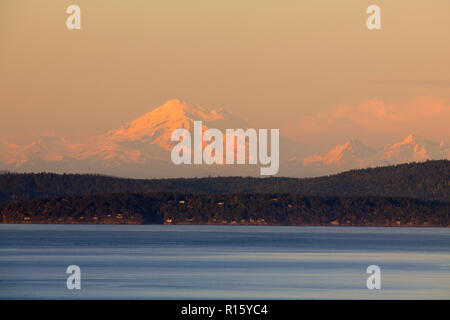 Mt. Baker in evening light rising behind the San Juan Island and Haro Strait, Victoria, BC, Canada Stock Photo