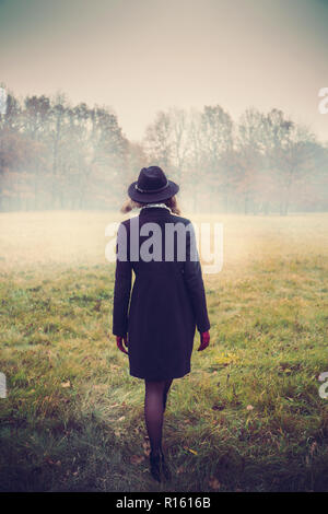 Girl walks across the field Stock Photo