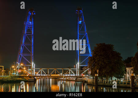 A lifting bridge over a canal is illuminated by blue lights Stock Photo