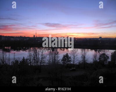 Beautiful sunset in the city view from high house window of the pond. Sleeping quarters in city Kiev. Stock Photo