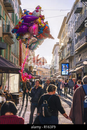 2 November 2018 - Nice, France. A man walking with colourful balloons in the old town of Nice, France Stock Photo