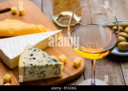 Cheese, olives and wineglass Stock Photo