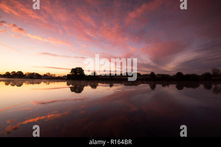 Sunrise reflections on the River Trent at Colwick Country Park in Nottingham, Nottinghamshire England UK Stock Photo