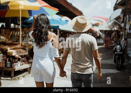 couple enjoying their time looking for souvenir in the market Stock Photo